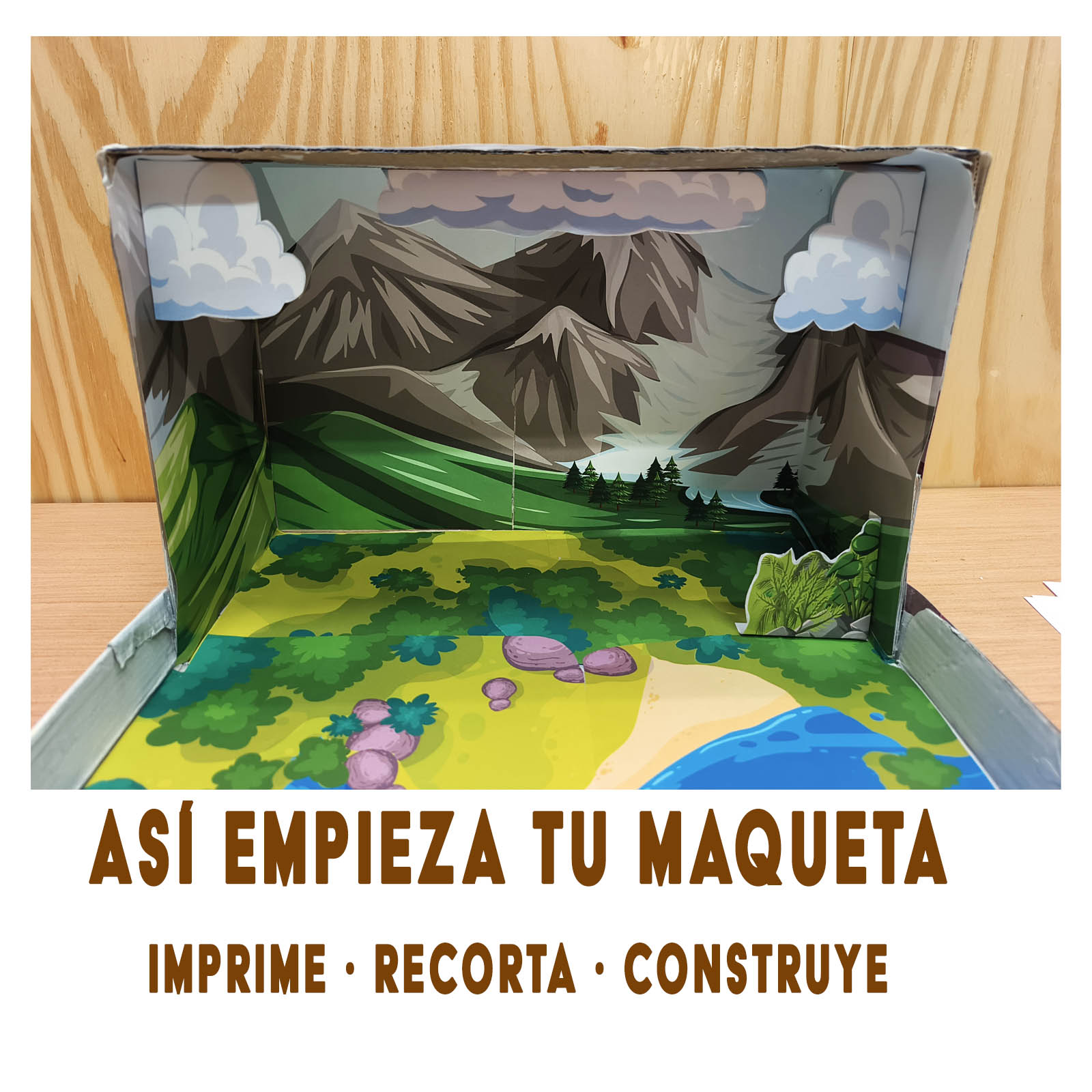 Maqueta del ciclo del agua en construcción con montañas, nubes y un río de papel dentro de una caja de cartón